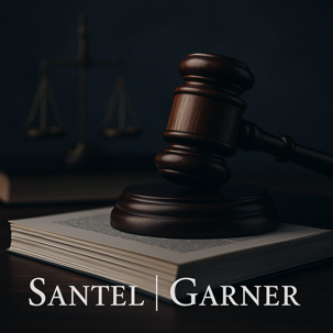 A wooden judge’s gavel rests on an open legal book atop a dark wooden desk, with brass scales of justice blurred in the background. At the bottom center, the law firm name 'Santel | Garner' appears in elegant serif font.